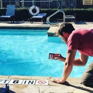 A Technician Tests the PH Balance of the water in a swimming pool
