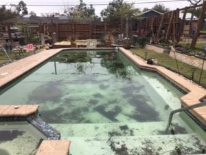 A pool that has been damaged after a natural disaster. 