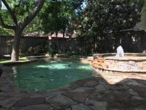 a pool and spa surrounded by stone