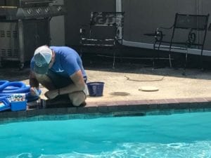 a pool company testing a pools water chemicals