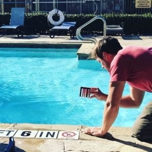 a man checking pool water chemicals
