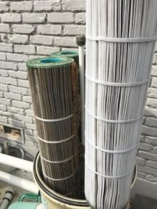 clean pool filter next to a dirty filter