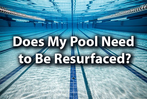 A gorgeous clear pool with the words, "Does My Pool Need to Be Resurfaced?"